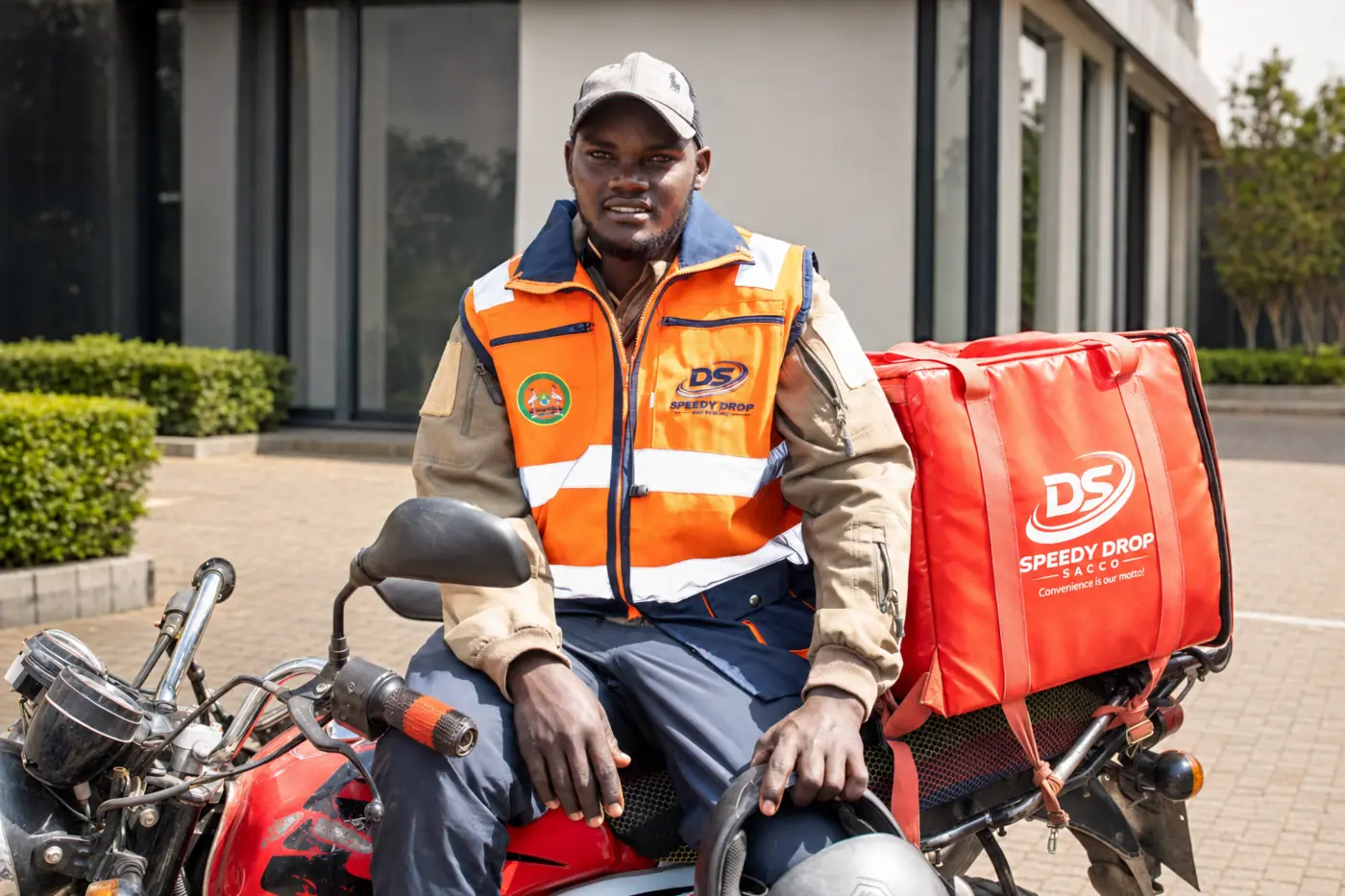 SpeedyDrop SACCO rider beside a branded delivery motorcycle